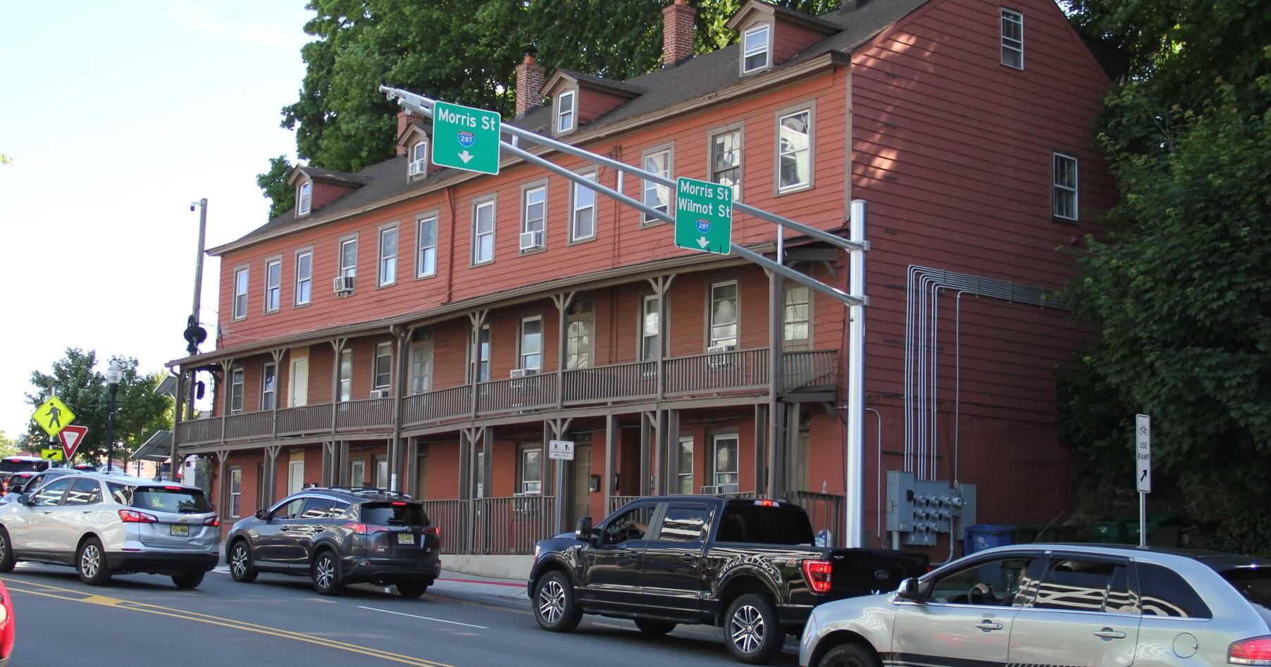 Red apartment building opposite the proposed site - Vimarsana News