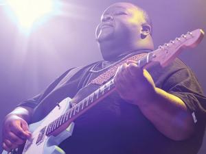Christone 'Kingfish' Ingram performing at guitar