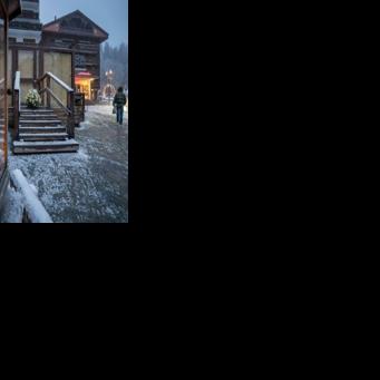 Flowers and candles have been left by the entrance to Le Constellation bar in Crans-Montana
