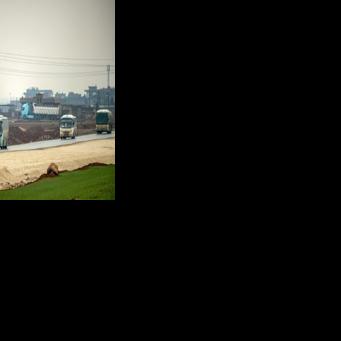 Buses in a US military convoy transporting Islamic State group detainees being transferred to Iraq from Syria