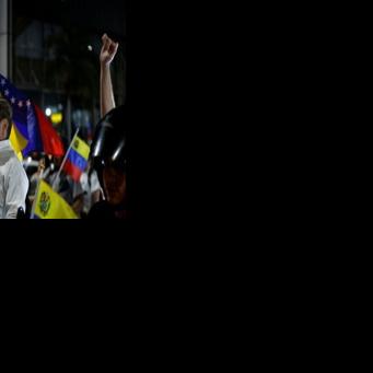 Venezuelan opposition politian leader Juan Pablo Guanipa waves a national flag after his release from Helicoide prison in Caracas on February 8, 2026, before he was detained again