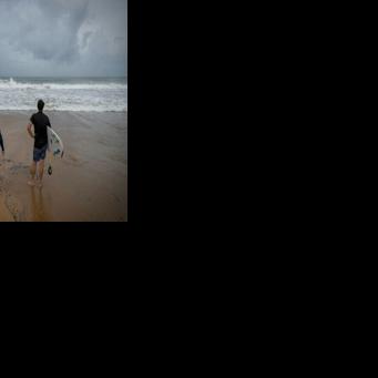 Surfers in Luquillo, Puerto Rico survey conditions with Hurricane Erin approaching, the first of what is expected to be a particularly intense Atlantic season