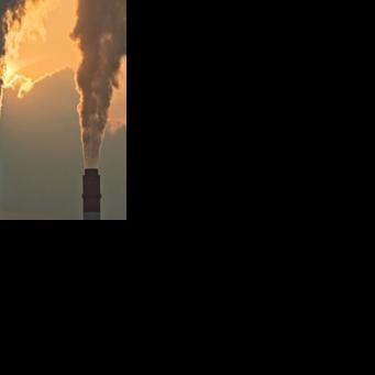 Smoke rises from chimneys at a power plant during sunset in Taicang, in eastern China's Jiangsu province