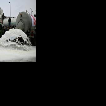 In Milan, ITalian farmers emptied milk tankers on to the streets in protest