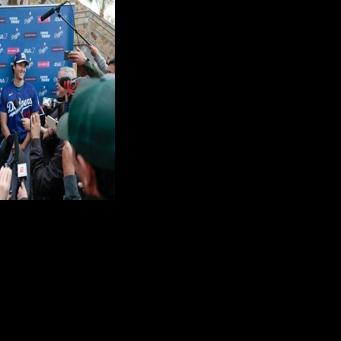 Shohei Ohtani of the Los Angeles Dodgers speaks to the media during spring training workouts in Arizona
