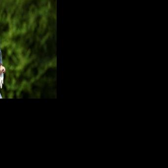 Defending champion Rory McIlroy of Northern Ireland walks on the 13th green during a practice round ahead of the 90th Masters