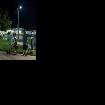 Media members report from in front of the Martin County Jail, where golfer Tiger Woods was held after being arrested on a charge of driving under the influence a car crash