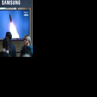 People at a train station in Seoul watch footage of a North Korean missile test