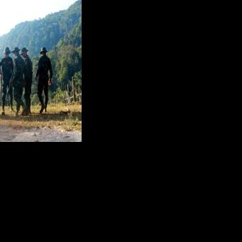 Fighters from Myanmar's rebel Kayan National Army stood guard on a hilltop overlooking a displaced people's camp in Pekon -- as voters went to the polls