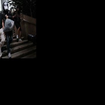 Kwok Yin-sang (L) leaves the High Court after a judge granted him bail in Hong Kong on May 20, 2025. He has been convicted of handling money belonging to his daughter, a wanted pro-democracy activist based overseas, in the first such verdict issued…