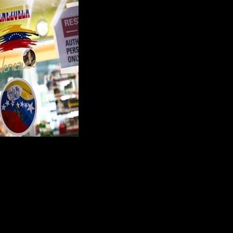 Venezuela-themed stickers decorate a window in the Doral food mart