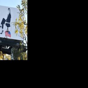 A billboard advertising the film “Melania” is seen vandalized in Southern California
