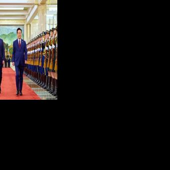 South Korea's President Lee Jae Myung (R) and China's President Xi Jinping (C) inspect honour guards during a welcoming ceremony at the Great Hall of the People in Beijing on January 5, 2026