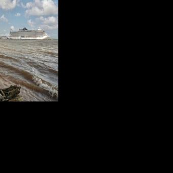 People on a beach along the Guama River watch cruise ships docked at the Port of Outeiro, which will host delegations attending the COP30 UN Climate Change Conference in Belem, Para state, Brazil, on November 6, 2025