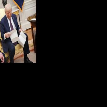 US President Donald Trump reads a letter from King Charles III given to him by British Prime Minister Keir Starmer inviting him to visit Britain in 2025