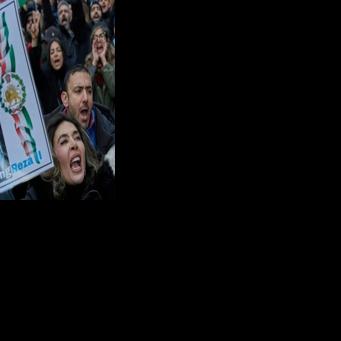 Some protesters in Paris carried images backing the son of the deposed shah