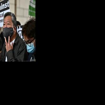 Pro-democracy activist Lee Cheuk-yan (C) arrives at a court in Hong Kong on April 16, 2021