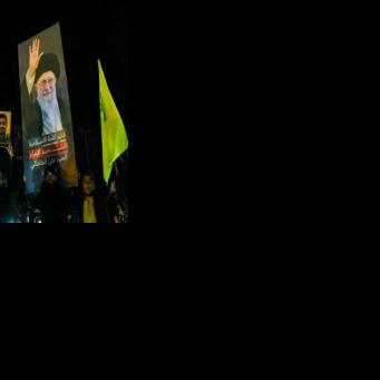 Supporters of Hezbollah in Beirut hold portraits of assassinated Iranian Supreme Leader Ayatollah Khamenei while celebrating the ceasefire with Israel as it takes effect