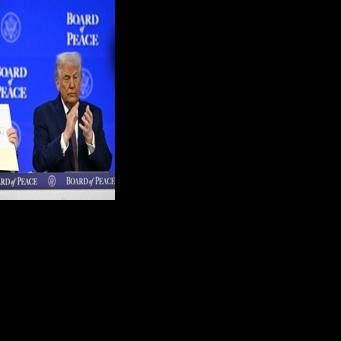 Azerbaijan's President Ilham Aliyev holds a signed founding charter of the "Board of Peace" as US President Donald Trump applauds during the World Economic Forum in Davos, Switzerland