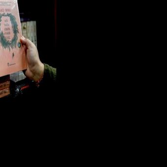 A man holds the book "The Sorrow of War" in a bookstore in Hanoi