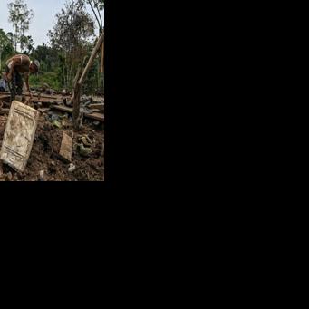 Farmer Jose Pena looks for belongings amid rubble after a bomb dropped by the Ecuadoran army in the Lago Agrio region of Ecuador on the border with Colombia