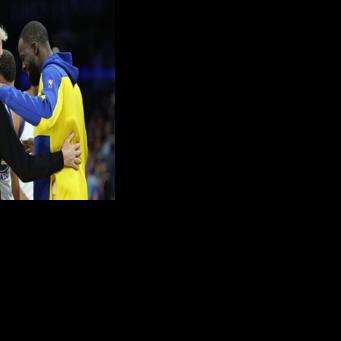 Head coach Steve Kerr, Stephen Curry and Draymond Green hug during the final moments of the Golden State Warriors' NBA play-in loss to the Phoenix Suns