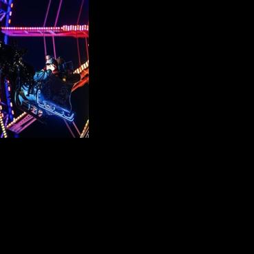 A performer dressed as Santa Claus greets visitors as he rides his sleigh with reindeers over a Christmas market in Berlin