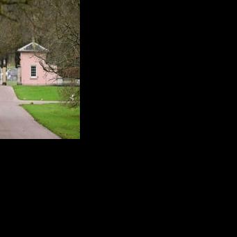Police officers walk towards the entrance to Royal Lodge, a 30-room property in Windsor and past residence to Britain's former prince Andrew where police said they are still conducting a search
