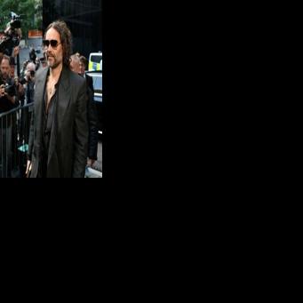 British comedian and actor Russell Brand arrives at Southwark Crown Court and was due to enter pleas for five sexual offence charges including rape and sexual assault