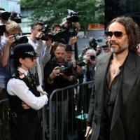 British comedian and actor Russell Brand arrives at Southwark Crown Court and was due to enter pleas for five sexual offence charges including rape and sexual assault
