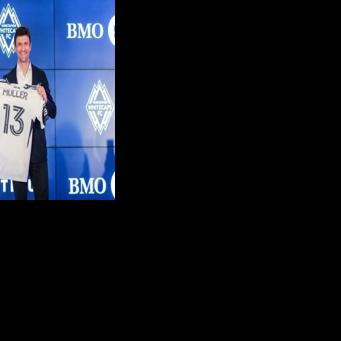 Vancouver Whitecaps' new signing Thomas Mueller of Germany holds his jersey as he is introduced by the Major League Soccer club