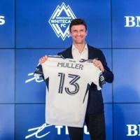 Vancouver Whitecaps' new signing Thomas Mueller of Germany holds his jersey as he is introduced by the Major League Soccer club