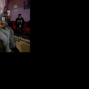 Relatives holding portraits of those believed to to have gone missing while making the journey to Europe through Libya