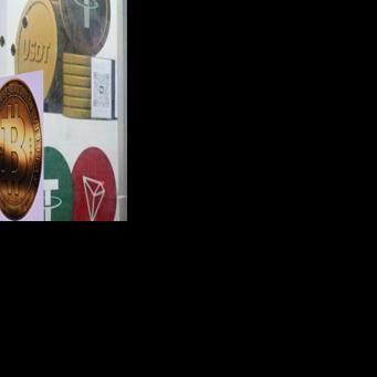 The symbols of bitcoin and the stablecoin Tether (USDT) are displayed at a cryptocurrency store