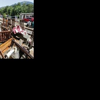 A Sri Lankan flood victim sorts out his belongings by railway tracks in Kandy. The authorities have issued fresh landslide warnings as monsoon storms make hillsides unstable