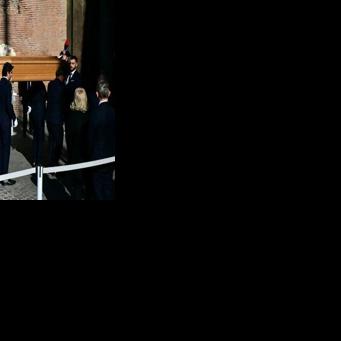 Pallbearers carry the coffin of the late Italian fashion designer Valentino Gavarani to enter the Basilic of Santa Maria degli Angeli e dei Martiri for a funeral ceremony, in Rome on January 23, 2026.