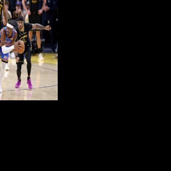 Oklahoma City Thunder star Shai Gilgeous-Alexander drives against Moses Moody and Gary Payton II of the Golden State Warriors