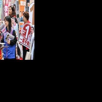 Supporters campaign for their candidates in the Legislative Council elections in Wanchai district of Hong Kong on December 7, 2025.