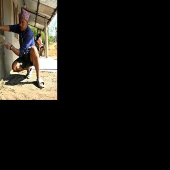 Father-of-four Dipak Magar rushes to plaster his house before returning to work in Saudi Arabia