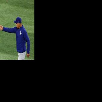 Los Angeles Dodgers manager Dave Roberts, at right taking the ball from Shohei Ohtani, says the Japanese batting and pitching star will not take the mound for defending champion Japan in March's World Baseball Classic