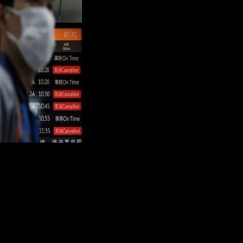 A flight information display board shows cancelled flights at Taipei's Songshan Airport. More than 100,000 passengers were expected to be affected by flight disruptions as a result of China's military drills