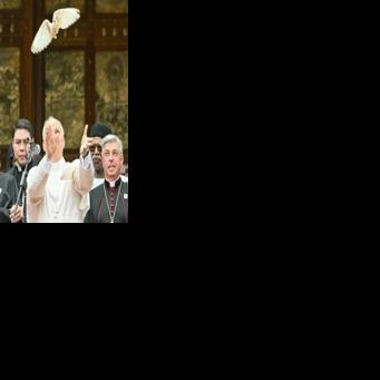 Pope Leo XIV releases a white dove after calling for peace in Cameroon