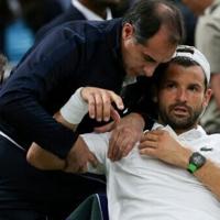 Bulgaria's Grigor Dimitrov receives treatment on Wimbledon's Centre Court