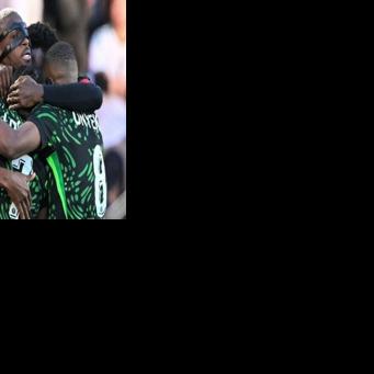 The masked Victor Osimhen celebrates with teammates as Nigeria beat Algeria to set up a semi-final against hosts Morocco