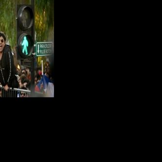 A man shows a portrait of the late Chilean dictator Augusto Pinochet (1973–1990) following the first results of the presidential runoff election in Santiago on December 14, 2025.