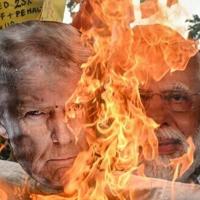 Opposition activists burned an effigy of US President Donald Trump and Indian Prime Minister Narendra Modi earlier this month as negotiations took place under a cloud of US tariffs