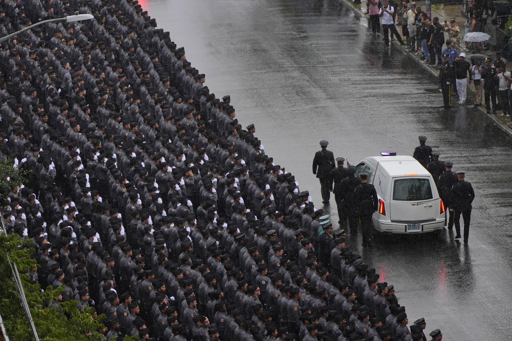Mourners honor the NYPD officer killed in the attack at the NFL ...