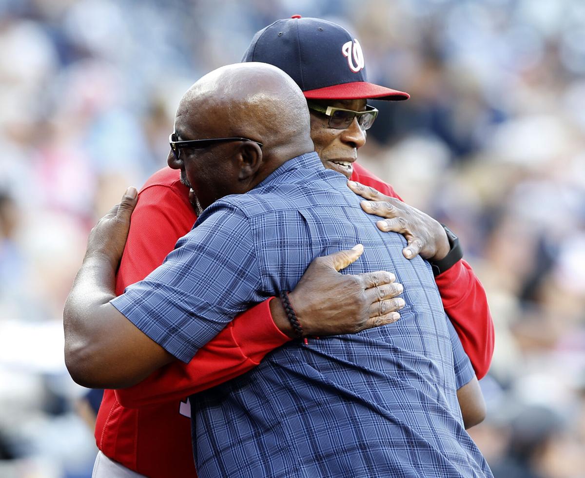 Chicago Cubs manager Lou Piniella, left, hugs Cincinnati Reds