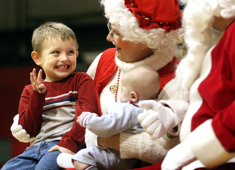 brian east shows mrs claus how old he is during a visit thursday night at the haven house christmas party at the nachand fieldhouse in jeffersonville - How Old Is Christmas brian east shows mrs claus how old he is during a visit thursday night at the haven house christmas party at the nachand fieldhouse in jeffersonville - How Old Is Christmas