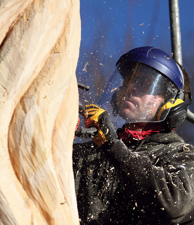 Sculpting stumps Chain saw artist creating sculpture on Utica Pike